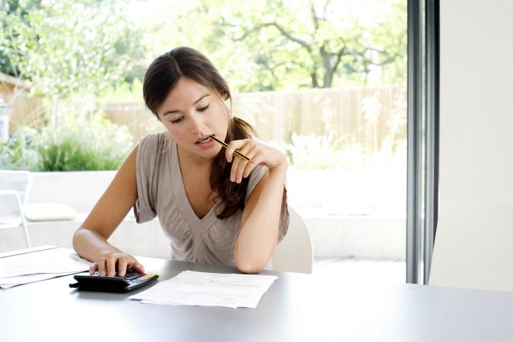 Woman Using Calculator