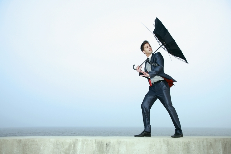 Man with Inverted Umbrella Representing Risk